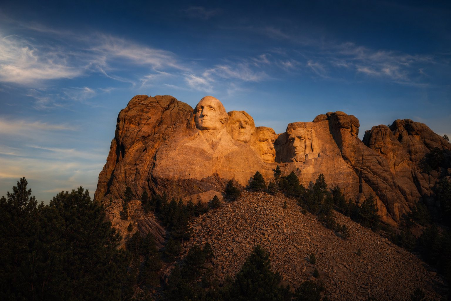 Modern photograph of Mount Rushmore and the Black Hills at sunset representing Nation Movers' South Dakota service area